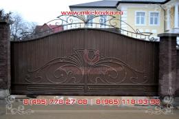 Кованые ворота закрытого типа в коричневом цвете, основная композиция рисунка ворот состоит из классических элементом и крупного орнамента в центральной части ворот   №197 от 12 500 руб. за м2 №226 от 12 500 руб. за м2